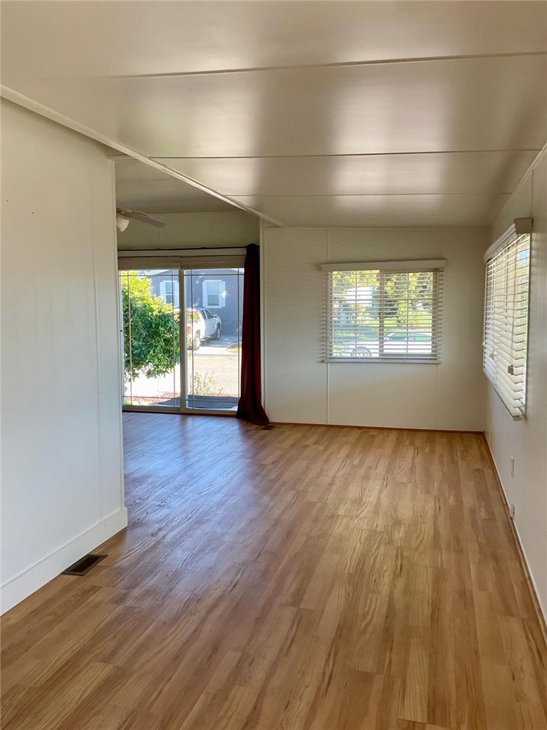 1180 Starlite Drive Nipomo, CA 93444 - Photo 4 of 35 an empty room with wooden floor and windows