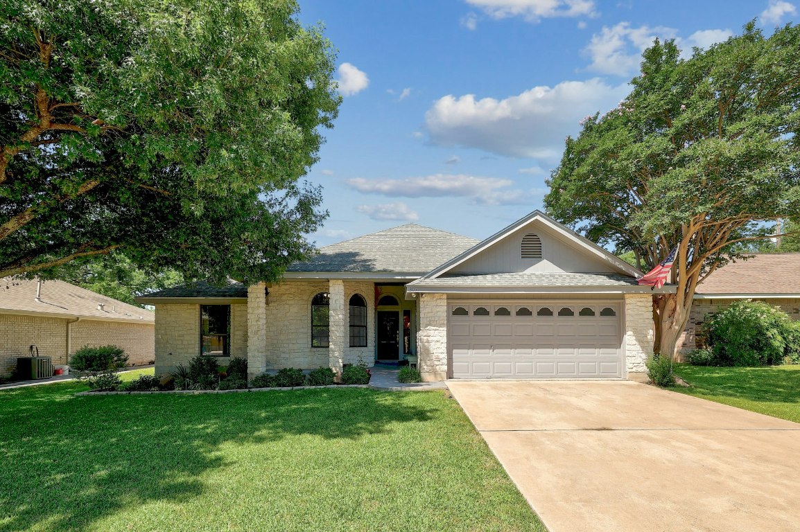 305 Rockcrest Drive Georgetown, TX 78628 - Photo 1 of 1 a front view of a house with a yard and garage