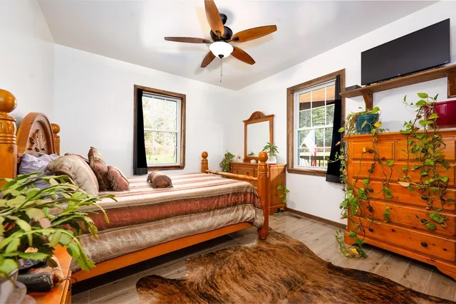 a bedroom with bed and window