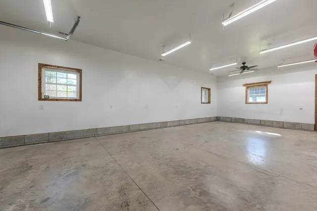 a bathroom with a granite countertop toilet sink and mirror