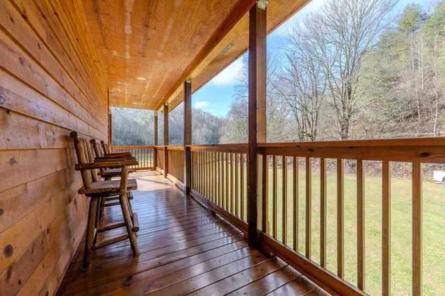 a view of a balcony with furniture and wooden floor