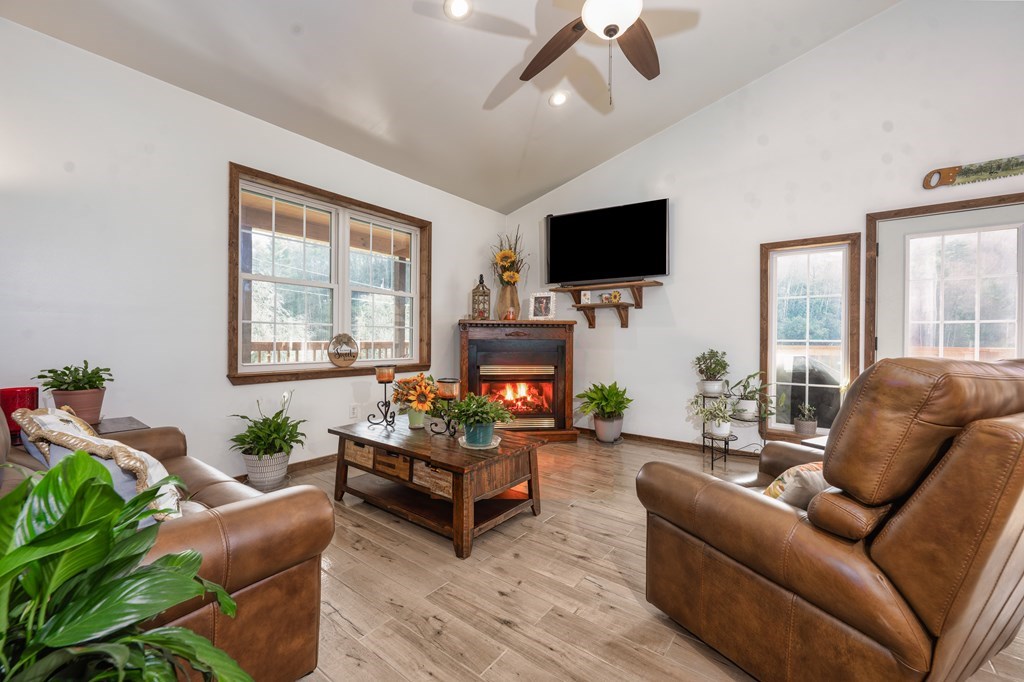 3234 Winding Stairs Road Topton, NC 28781 - Photo 6 of 32 a living room with furniture a flat screen tv and a large window