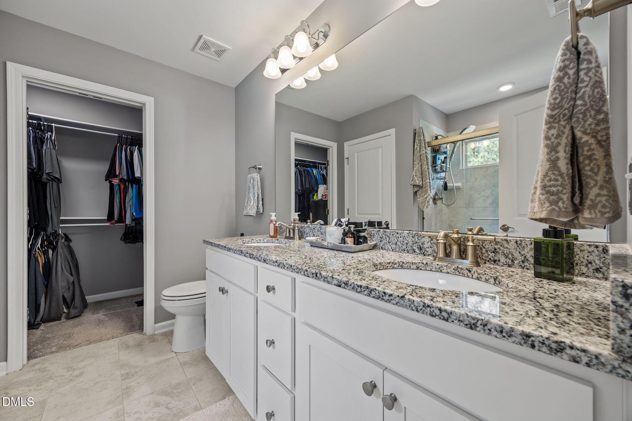 1108 Felman Road Durham, NC 27703 - Photo 18 of 28 a bathroom with a granite countertop sink a toilet and a mirror
