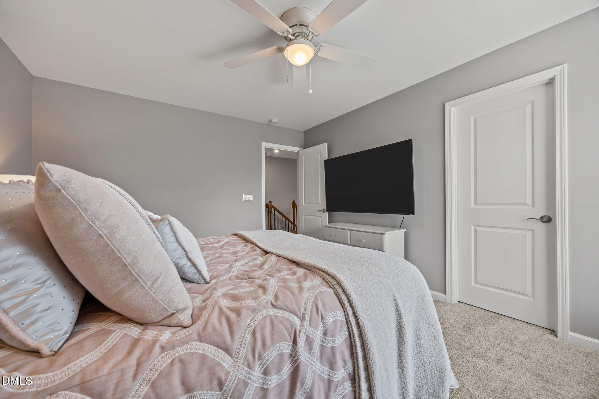 1108 Felman Road Durham, NC 27703 - Photo 23 of 28 a bedroom with a bed tv and a chandelier