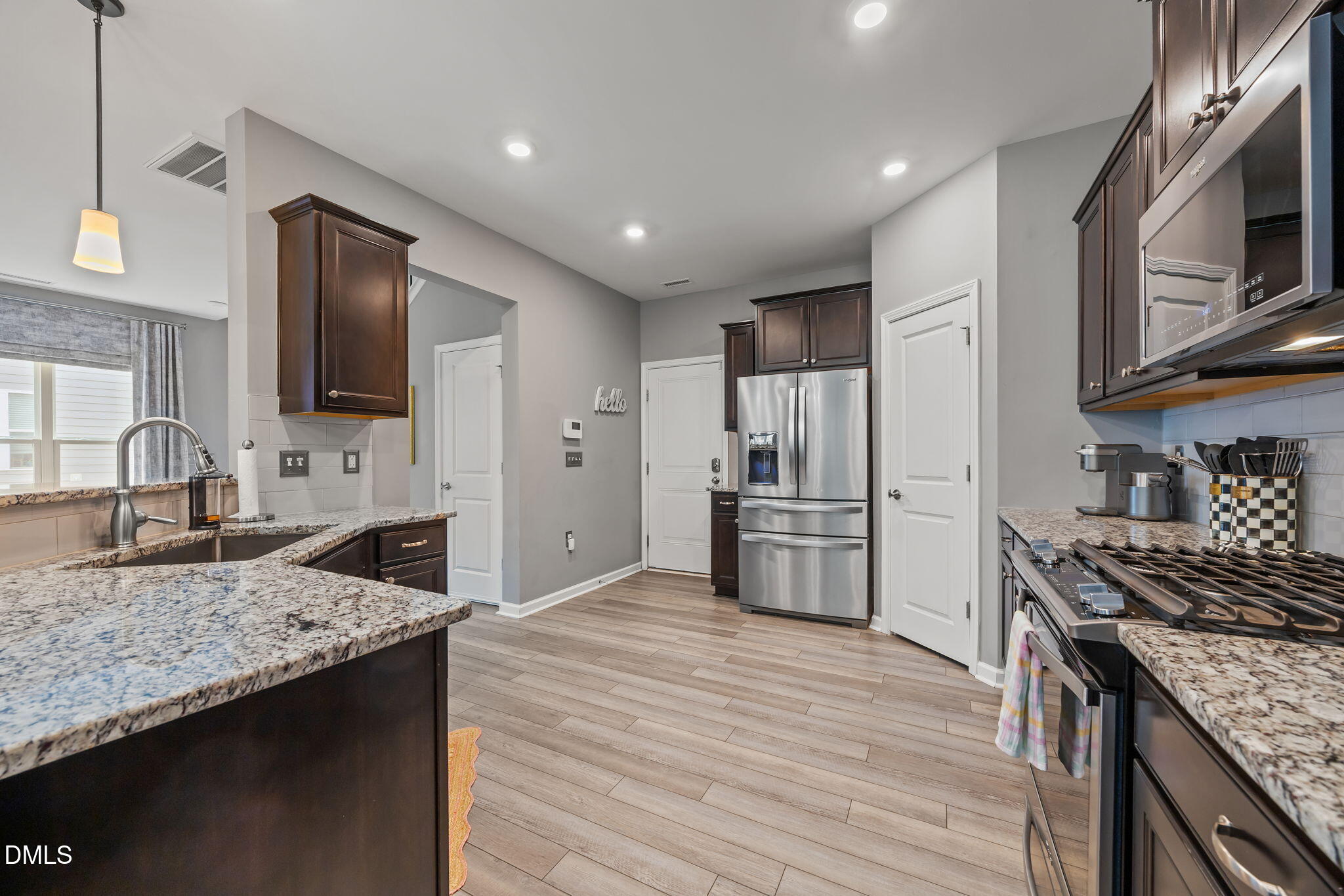 1108 Felman Road Durham, NC 27703 - Photo 8 of 28 a kitchen with granite countertop stainless steel appliances and wooden cabinets