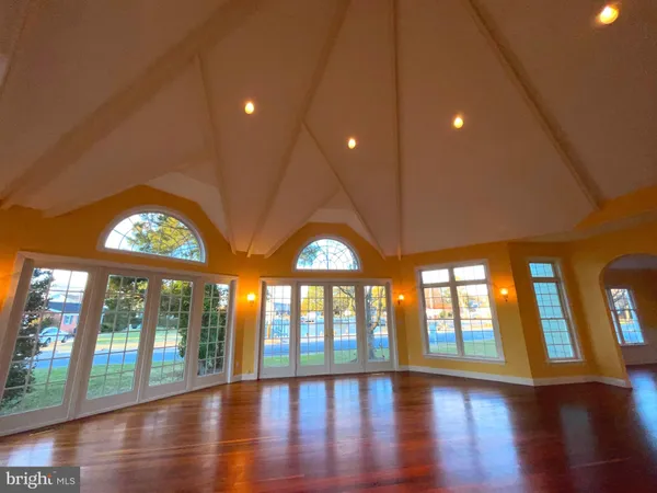 a view of a livingroom with wooden floor and a fireplace