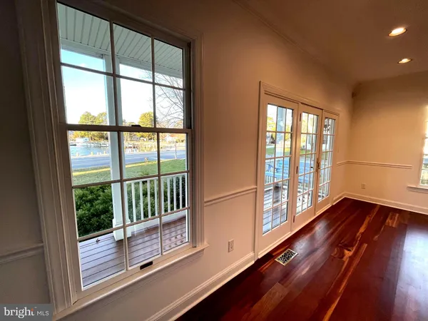 a living room with furniture kitchen appliances and a large window