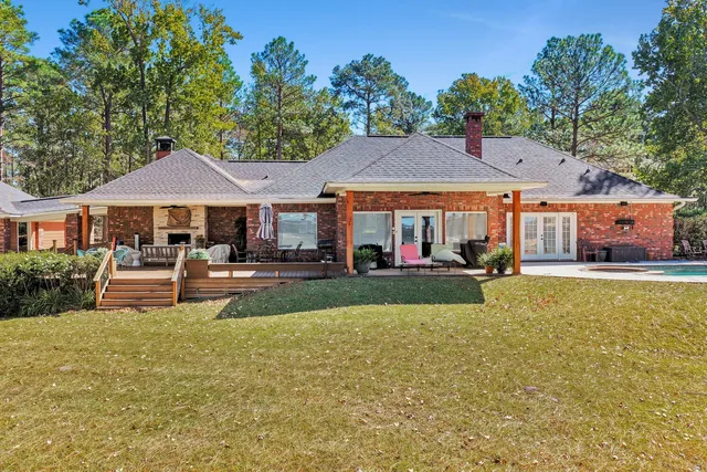 a patio with a table and chairs under an umbrella