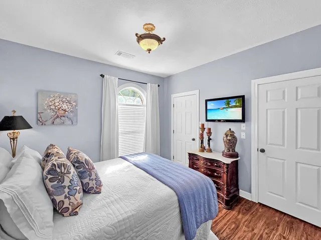 a bedroom with a bed and a chandelier