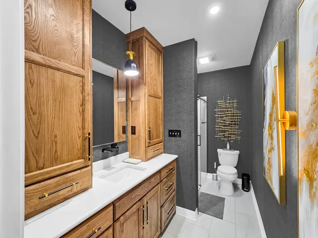 a spacious bathroom with a double vanity sink a mirror and a shower