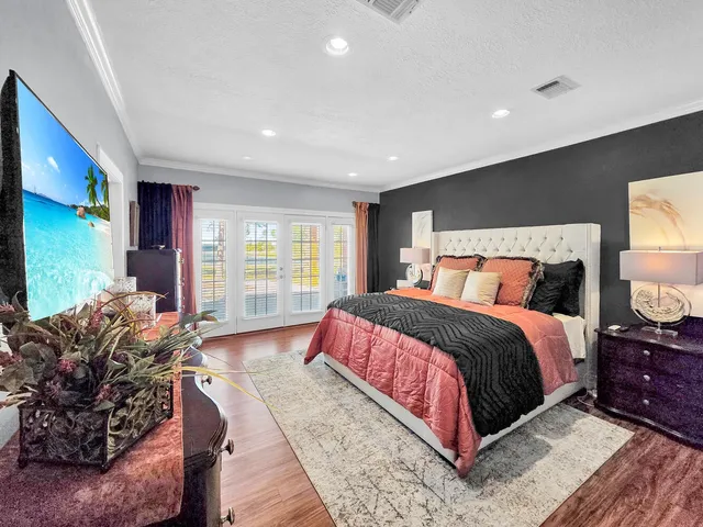 a bedroom with bed and large window