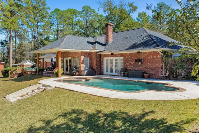 a view of a house with sitting area and a yard