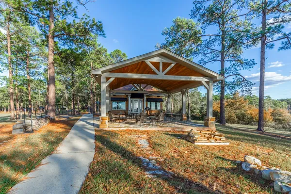 a view of a house with backyard and sitting area
