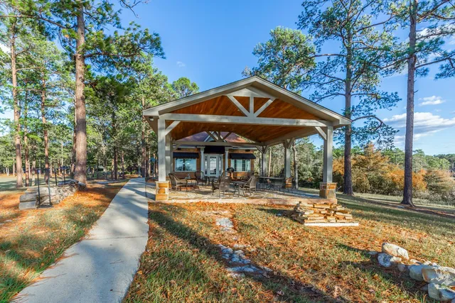 a view of a house with backyard and sitting area