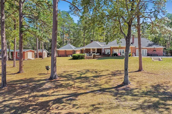 a view of a house with swimming pool next to a yard
