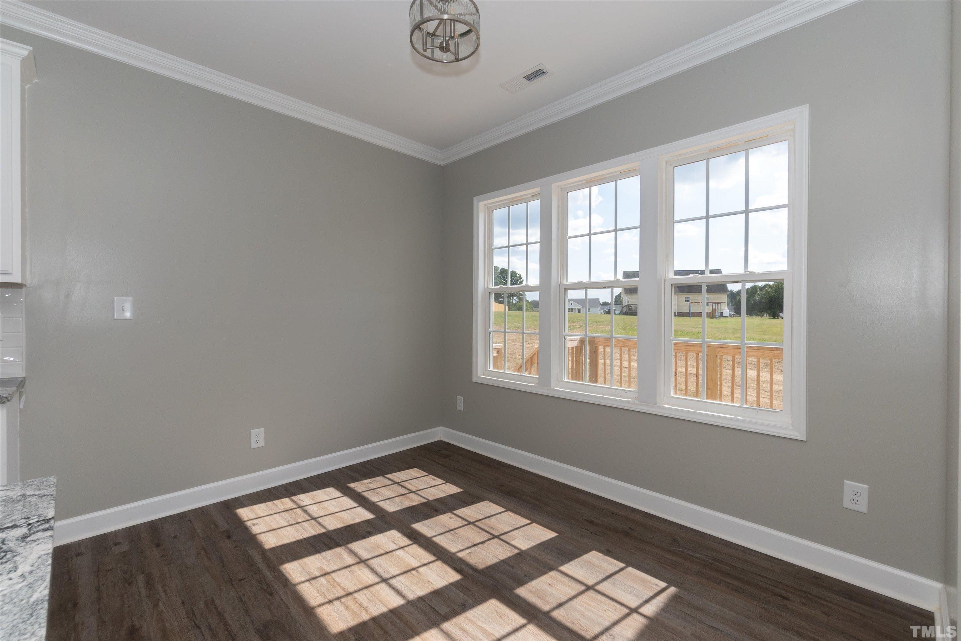 7149 Hill Road Spring Hope, NC 27882 - Photo 11 of 21 wooden floor in an empty room with a window