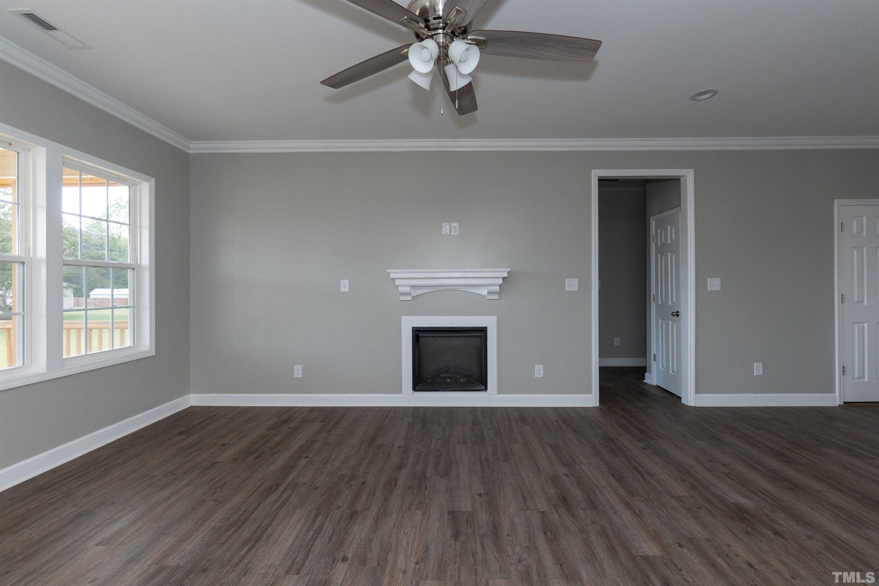 7149 Hill Road Spring Hope, NC 27882 - Photo 14 of 21 a view of an empty room with wooden floor and a window