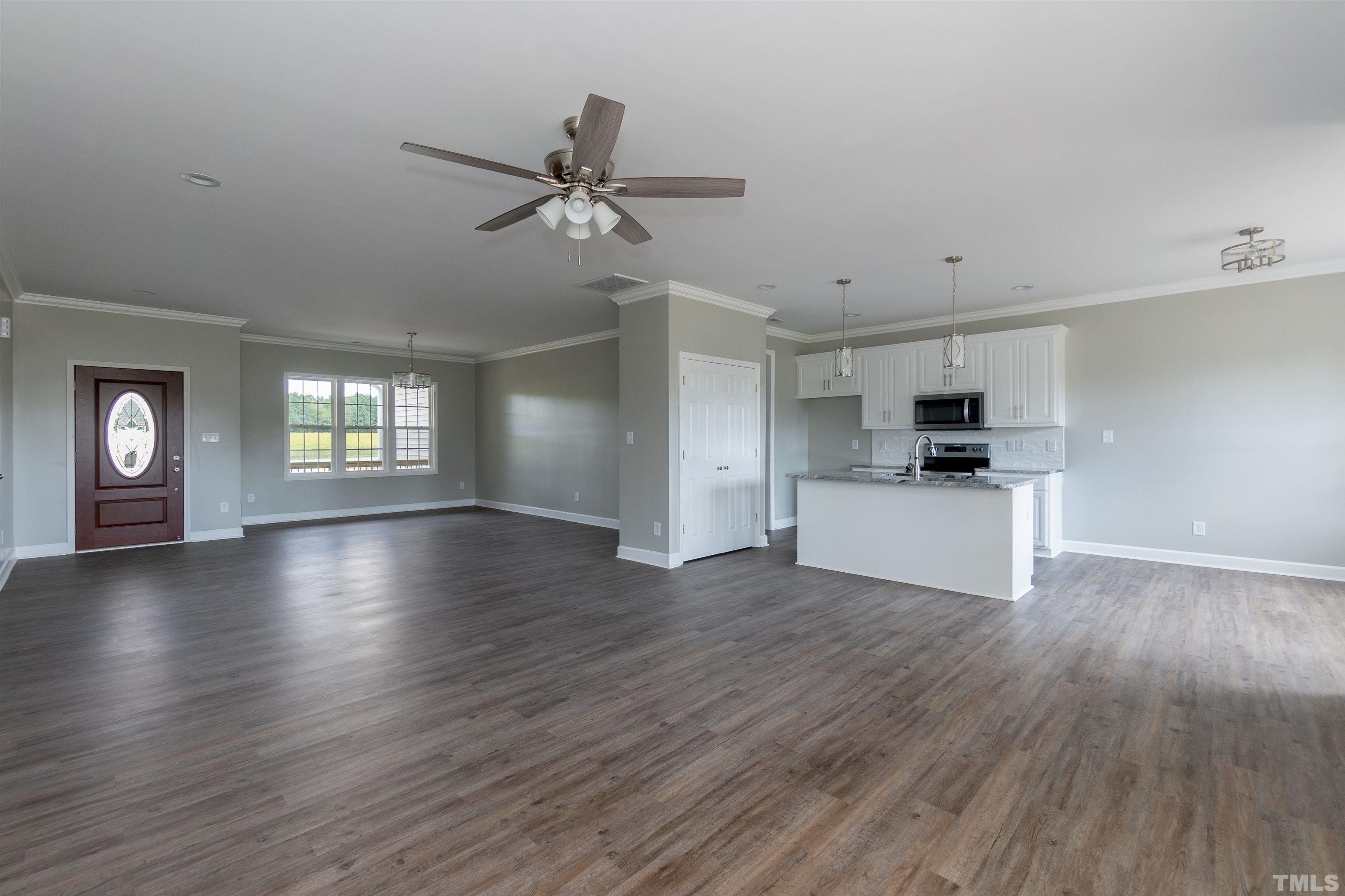 7149 Hill Road Spring Hope, NC 27882 - Photo 15 of 21 a view of empty room with wooden floor and window