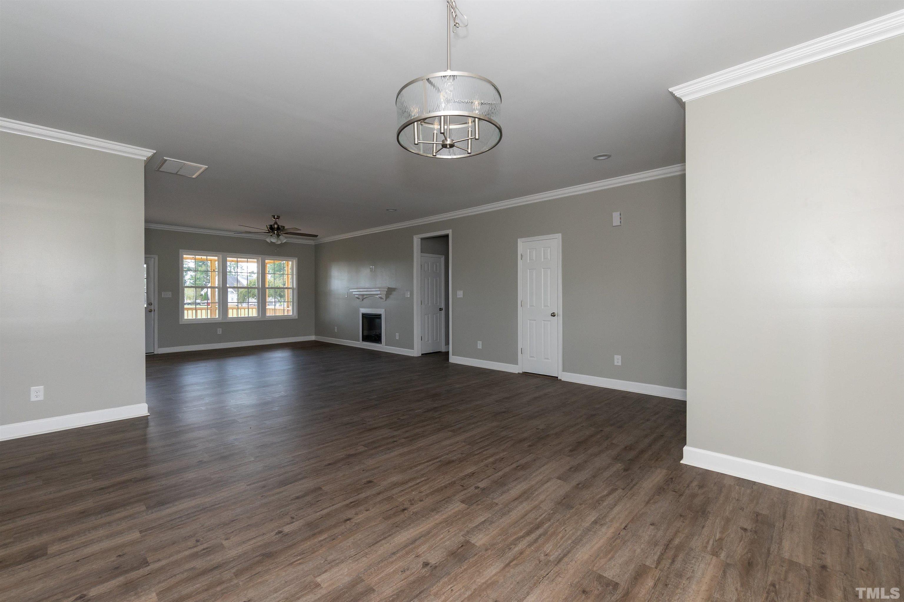 7149 Hill Road Spring Hope, NC 27882 - Photo 18 of 21 a view of an empty room with wooden floor and a window