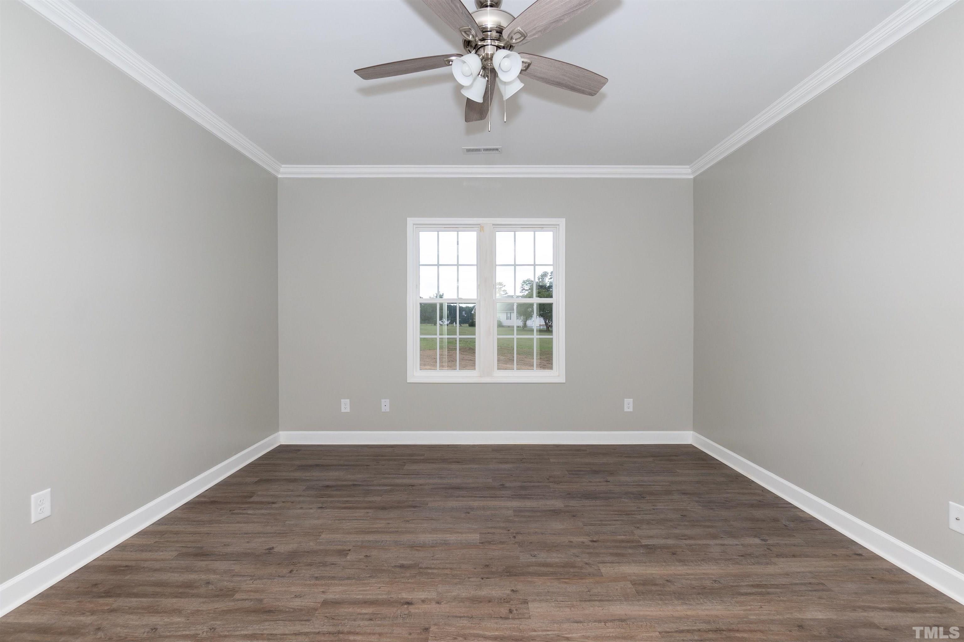 7149 Hill Road Spring Hope, NC 27882 - Photo 19 of 21 a view of an empty room with wooden floor and a window