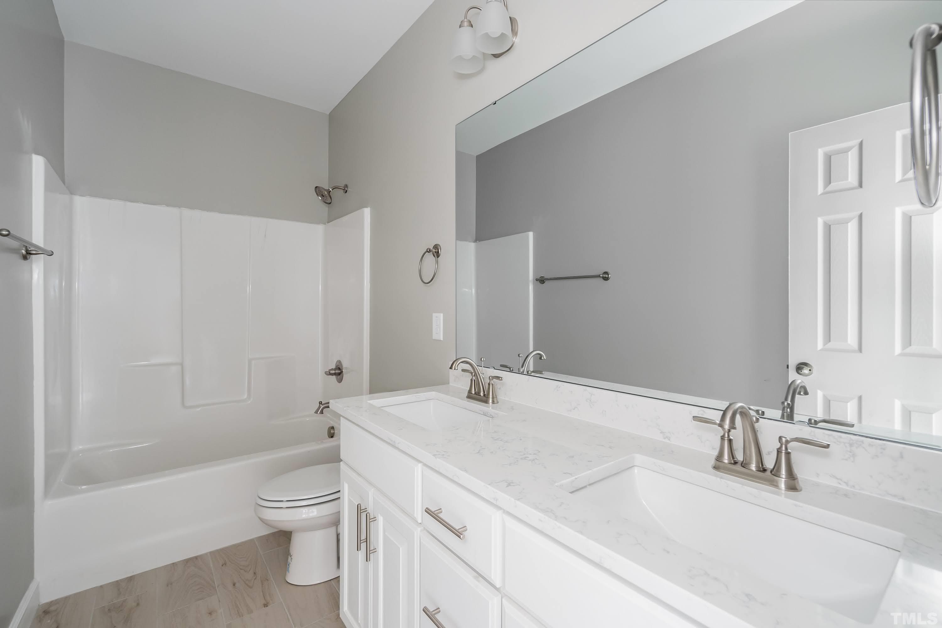 7149 Hill Road Spring Hope, NC 27882 - Photo 6 of 21 a bathroom with a sink a toilet and shower