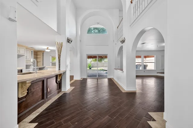 a view of a hallway view with wooden floor and staircase