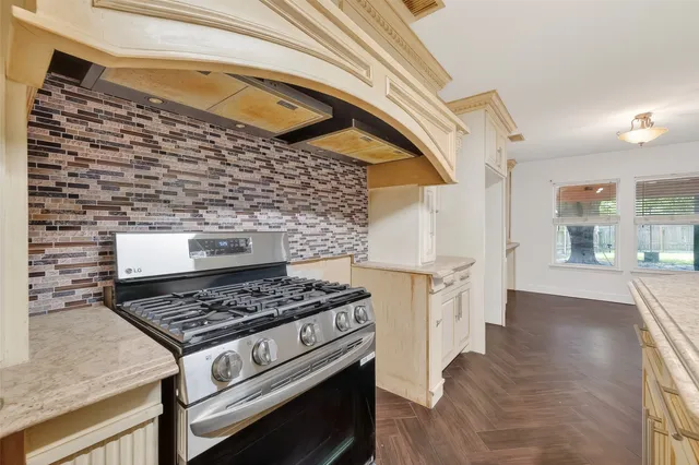 a kitchen with a stove and a cabinets