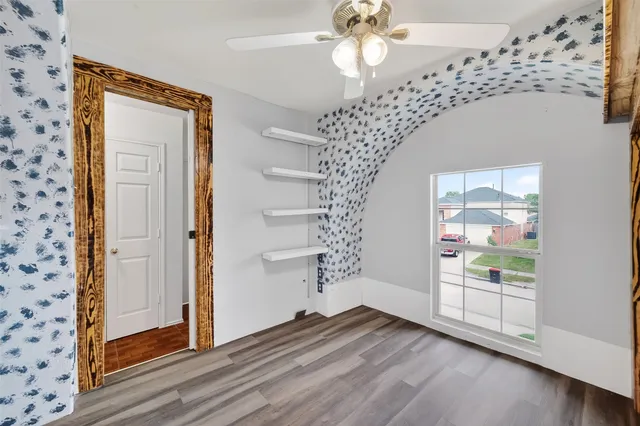 wooden floor in an empty room with a window