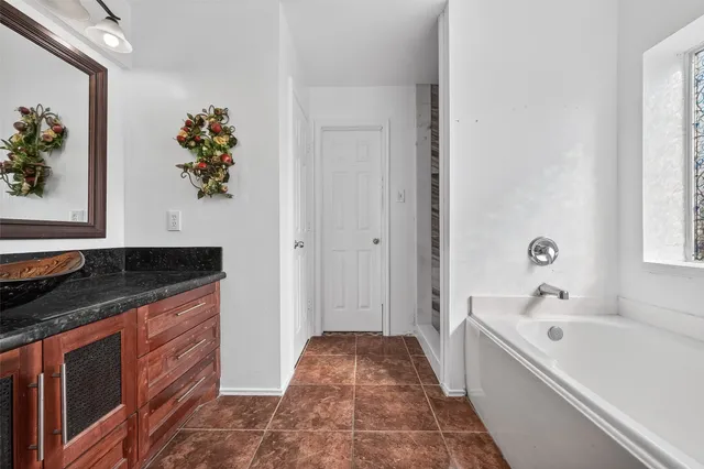 a bathroom with a sink a vanity and a bathtub