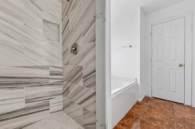 a view of staircase with white walls and white door