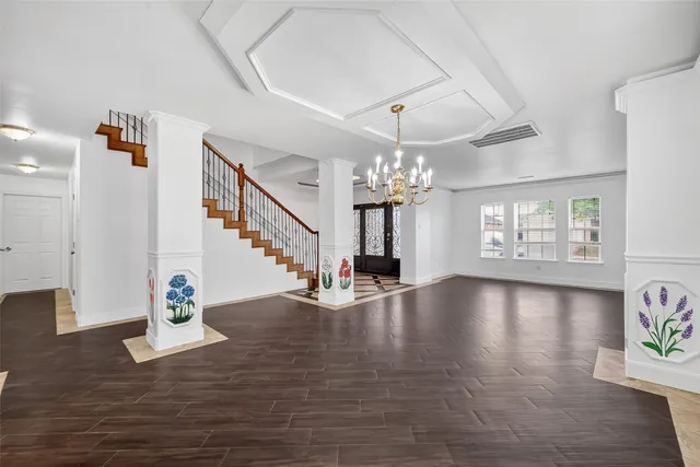 a view of an entryway and hall with wooden floor