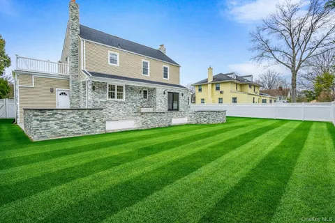 a view of a house with a yard and sitting area