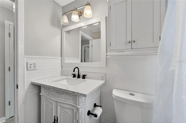 a bedroom with a large bed and a flat screen tv