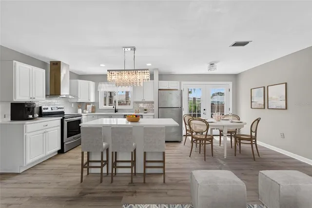 a kitchen with a center island wooden floor and a window