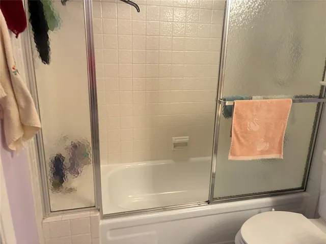 a bathroom with a toilet and a shower