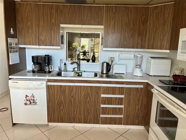 a kitchen with a sink cabinets and window