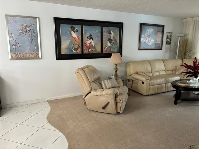 a living room with furniture and wall paintings