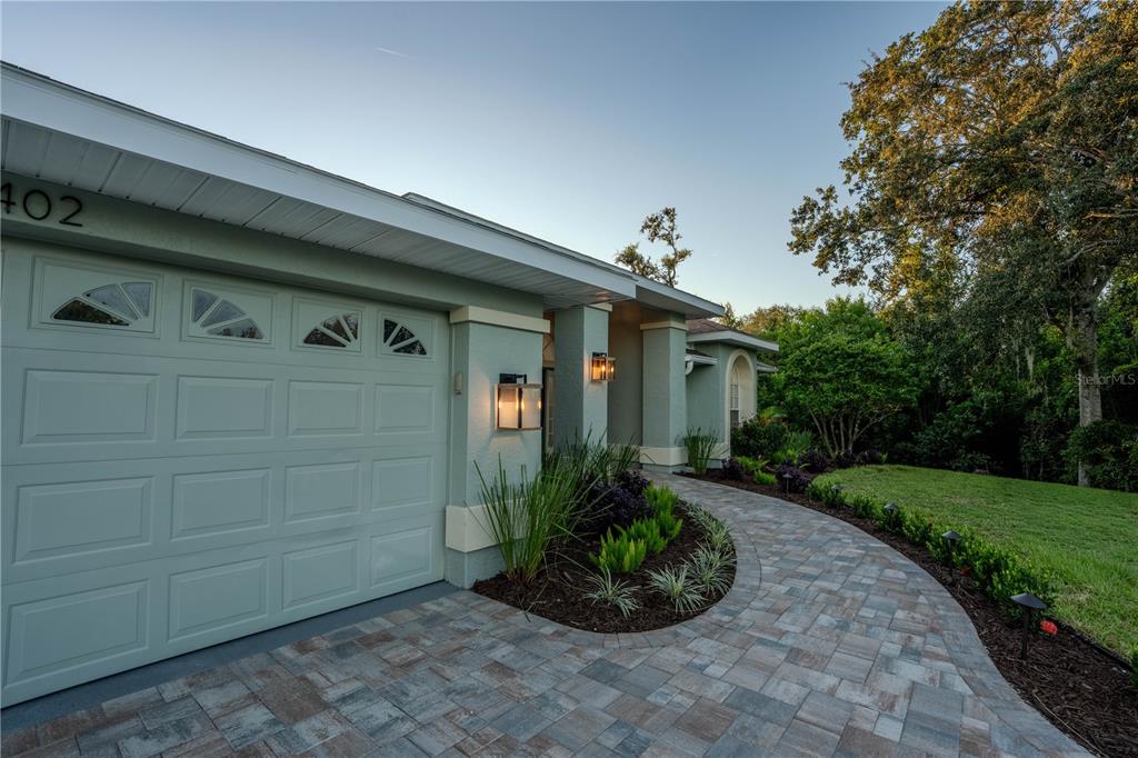 5402 Caruso Road Bradenton, FL 34203 - Photo 16 of 84 a front view of a house with garden