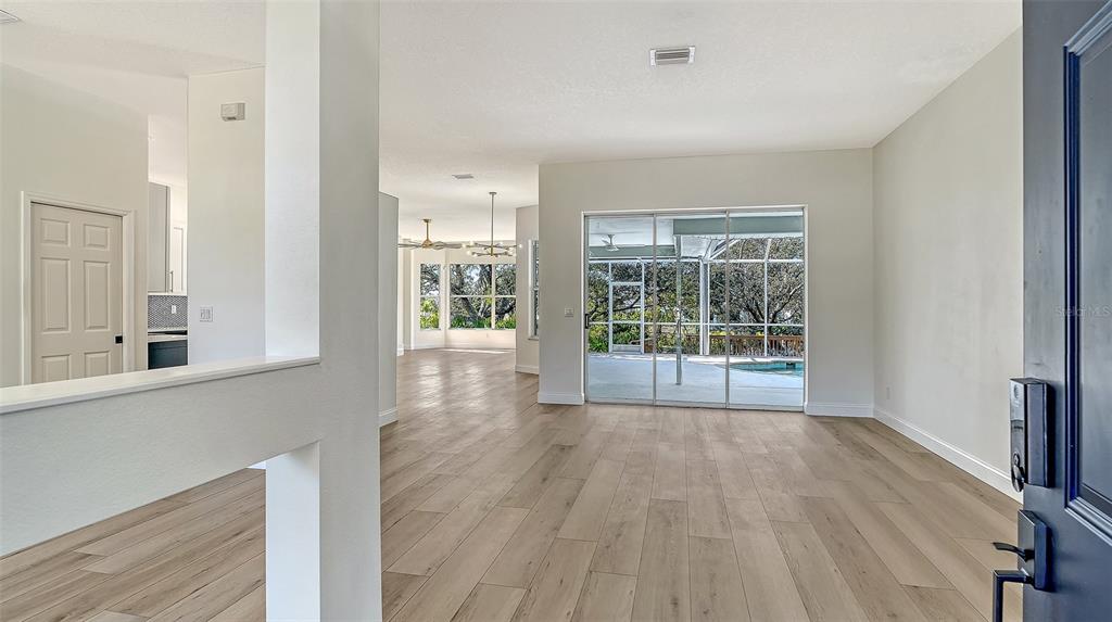 5402 Caruso Road Bradenton, FL 34203 - Photo 17 of 84 a view of a room with wooden floor and windows