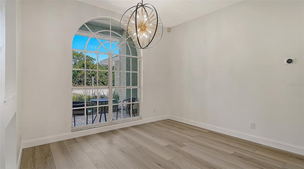 5402 Caruso Road Bradenton, FL 34203 - Photo 20 of 84 a view of empty room with wooden floor and fan