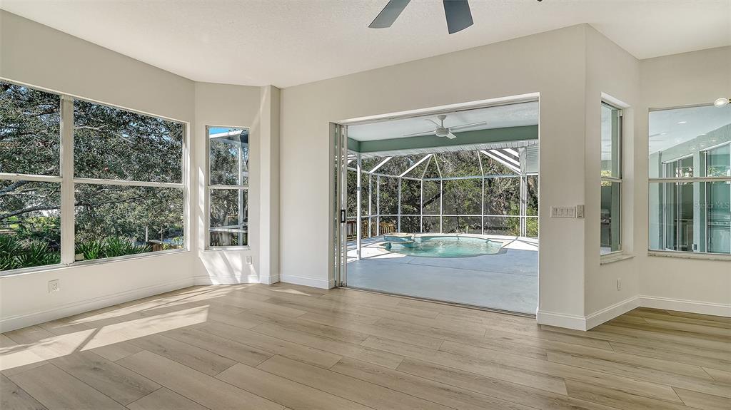 5402 Caruso Road Bradenton, FL 34203 - Photo 35 of 84 a view of an empty room with wooden floor and a window