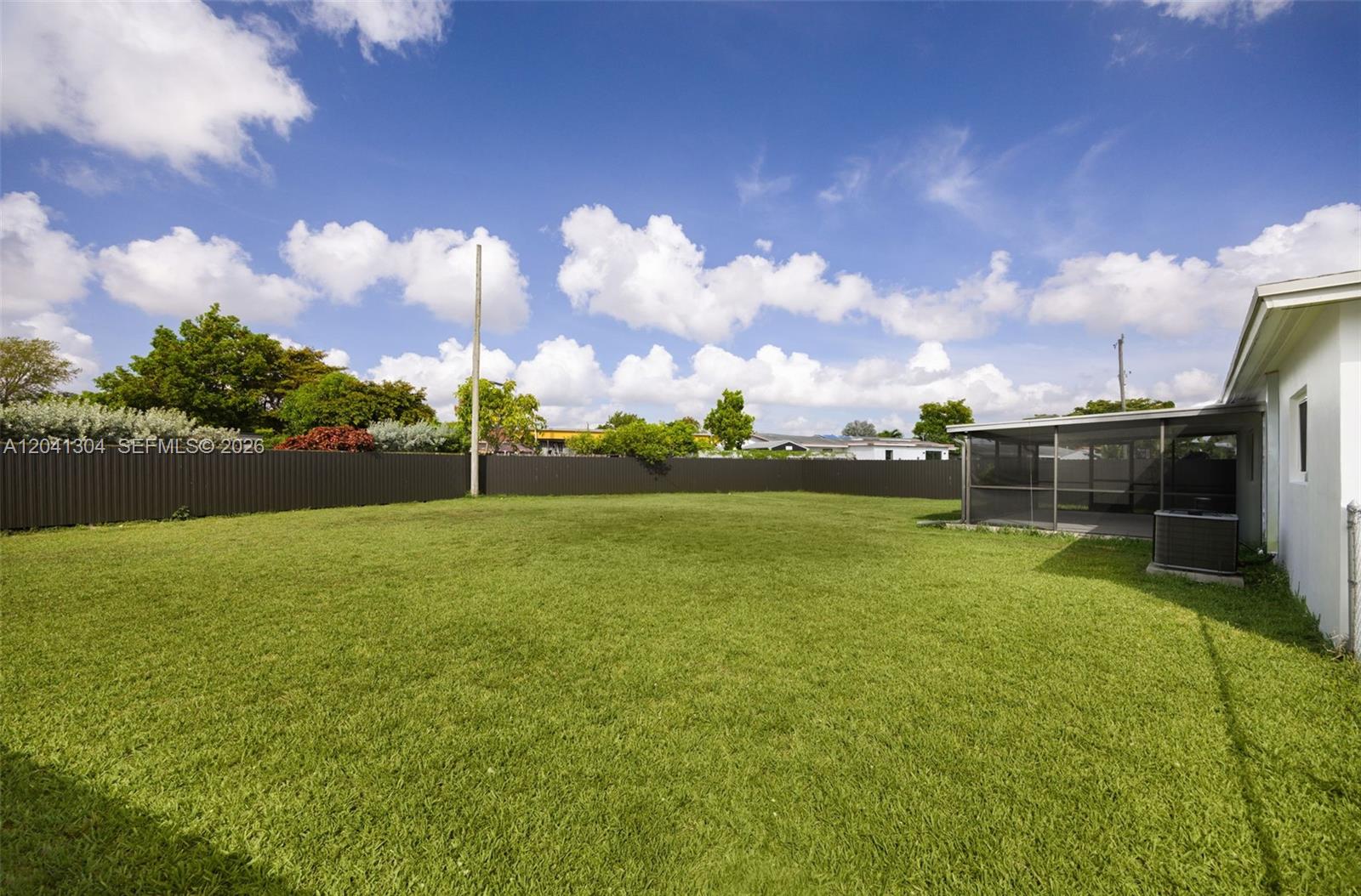 10340 Southwest 157th Street Miami, FL 33157 - Photo 23 of 24 Backyard – Generous backyard with a wide-open lawn and excellent privacy provided by perimeter fencing. A versatile outdoor setting with endless possibilities.