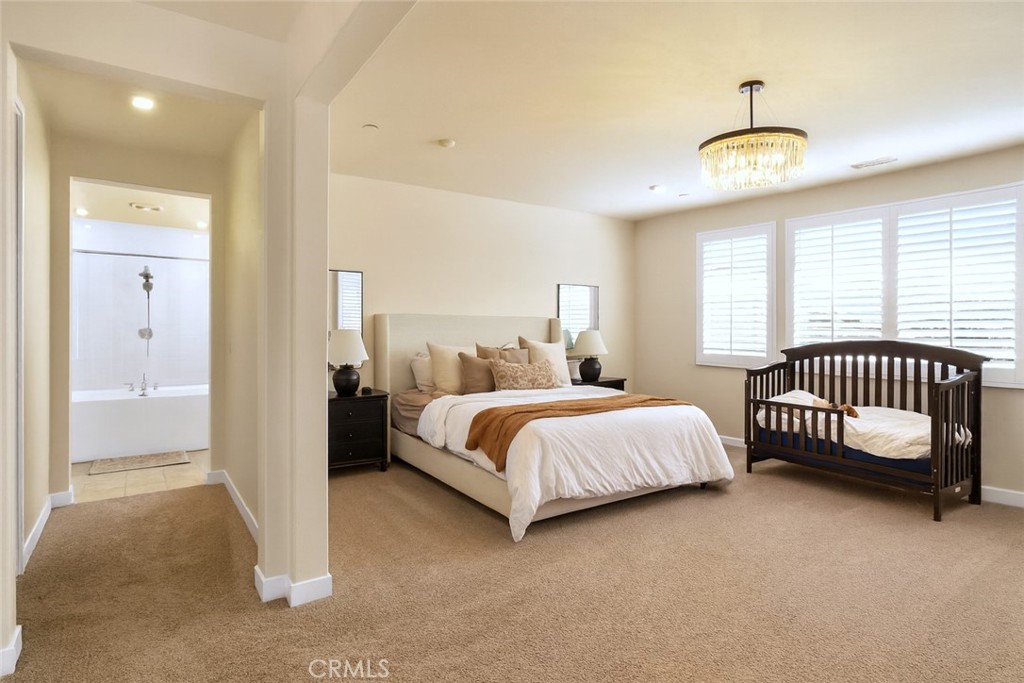 16155 New Canaan Court Riverside, CA 92504 - Photo 18 of 26 a bedroom with a bed and a window