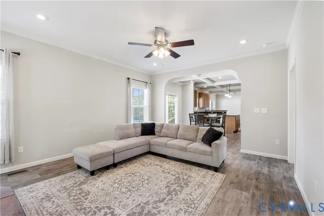 a living room with furniture and a wooden floor