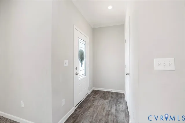 a view of hallway with window and hardwood floor