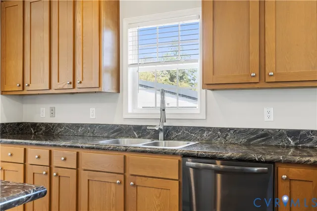 a kitchen with granite countertop cabinets and window