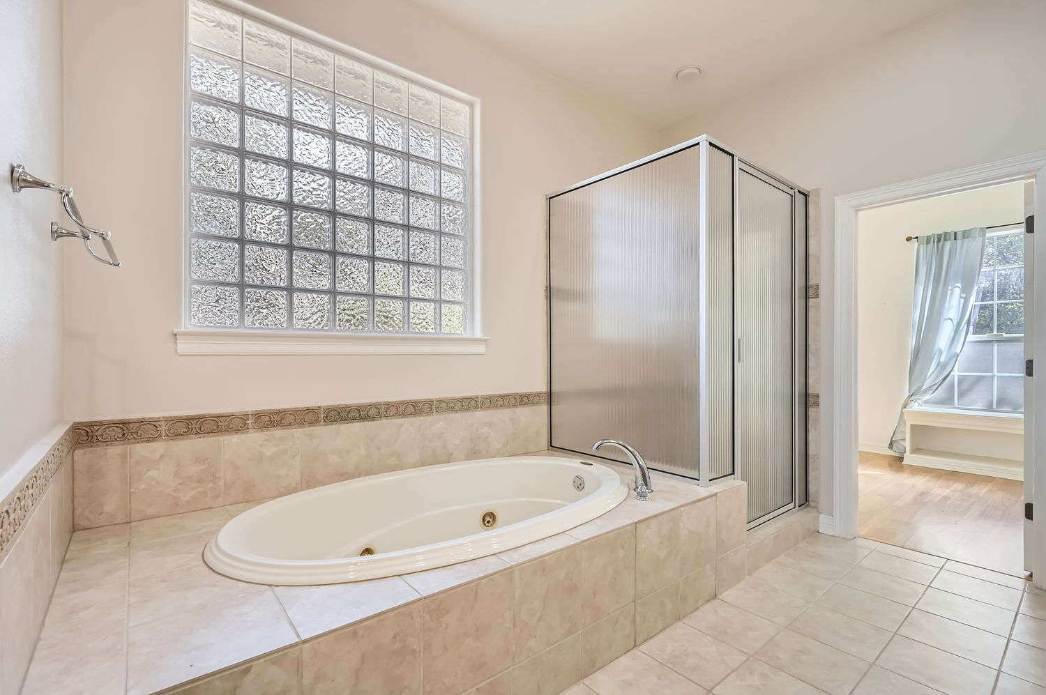 210 Amandas Way Leander, TX 78641 - Photo 20 of 38 Full bath with a stall shower, a whirlpool tub, and tile patterned floors