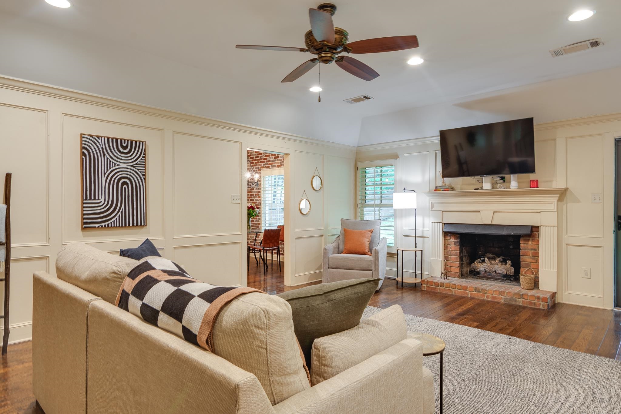791 North Tree Drive Collierville, TN 38017 - Photo 12 of 27 Living area featuring wood-finish flooring, a brick fireplace with a mantle, recessed lighting, and crown molding
