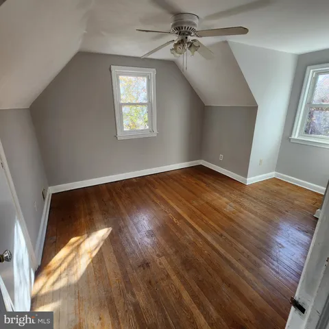 a view of an empty room window and wooden floor
