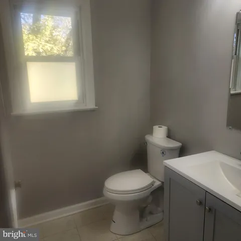 a white toilet sitting next to a window